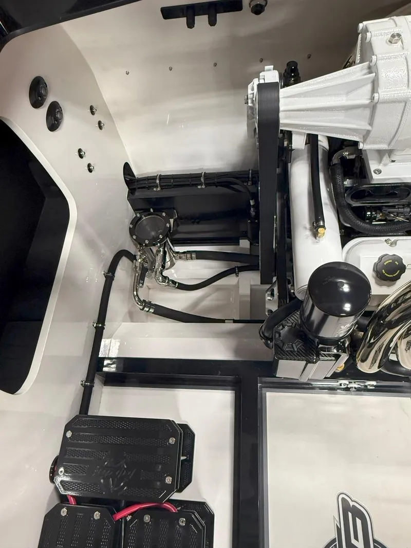 Slide: The Image of Engine compartment of a 2016 Daves Custom Boats M31, showcasing mechanical components. - 24