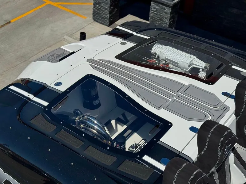 Slide: The Image of 2016 Daves Custom Boats M31 with sleek design and visible engine components. - 3