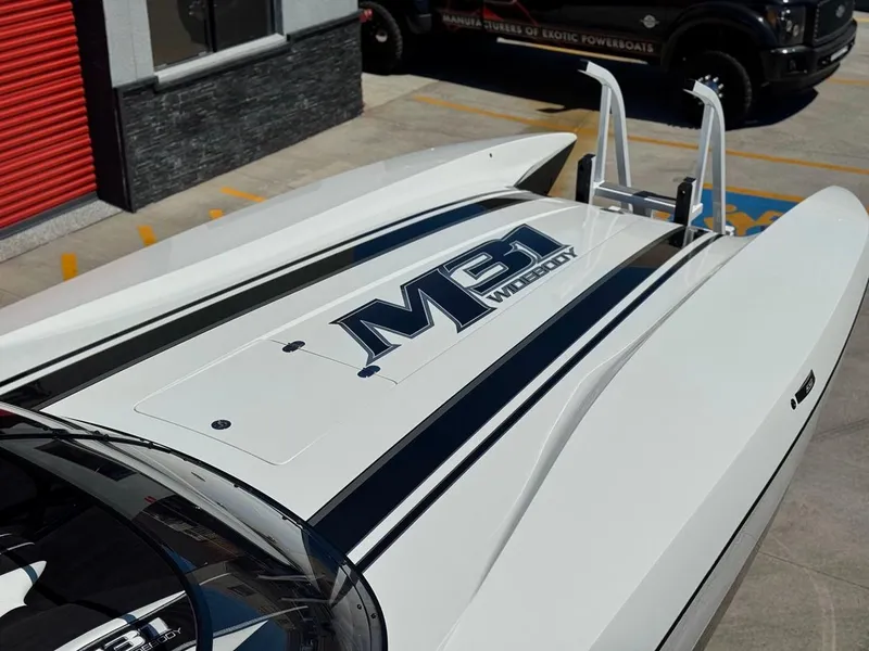 Slide: The Image of 2016 Daves Custom Boats M31 with sleek design and bold M31 branding. - 4