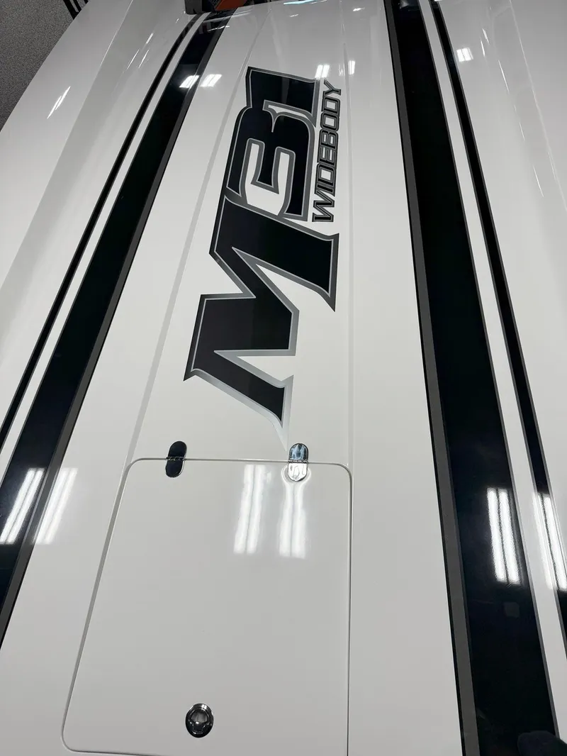 Slide: The Image of 2016 Daves Custom Boats M31, sleek design with bold logo on deck. - 5