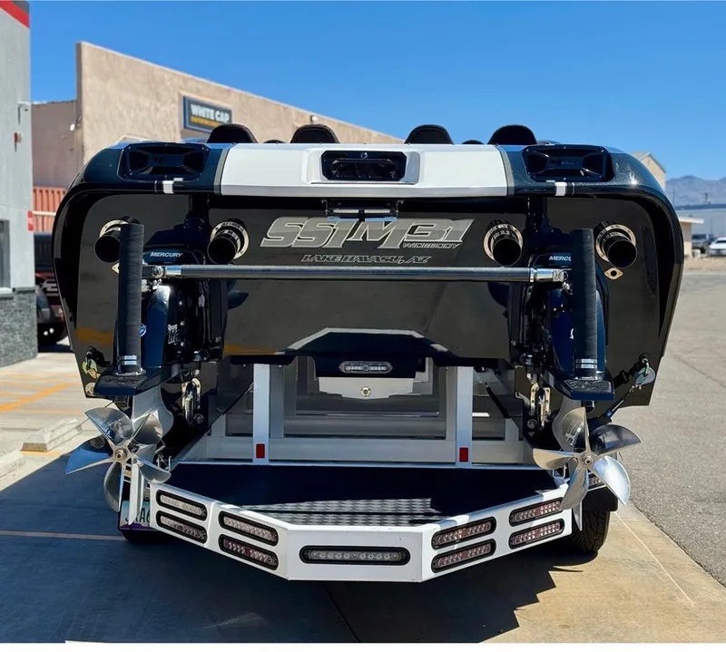 Slide: The Image of 2016 Daves Custom Boats M31, rear view with dual propellers and sleek design. - 7