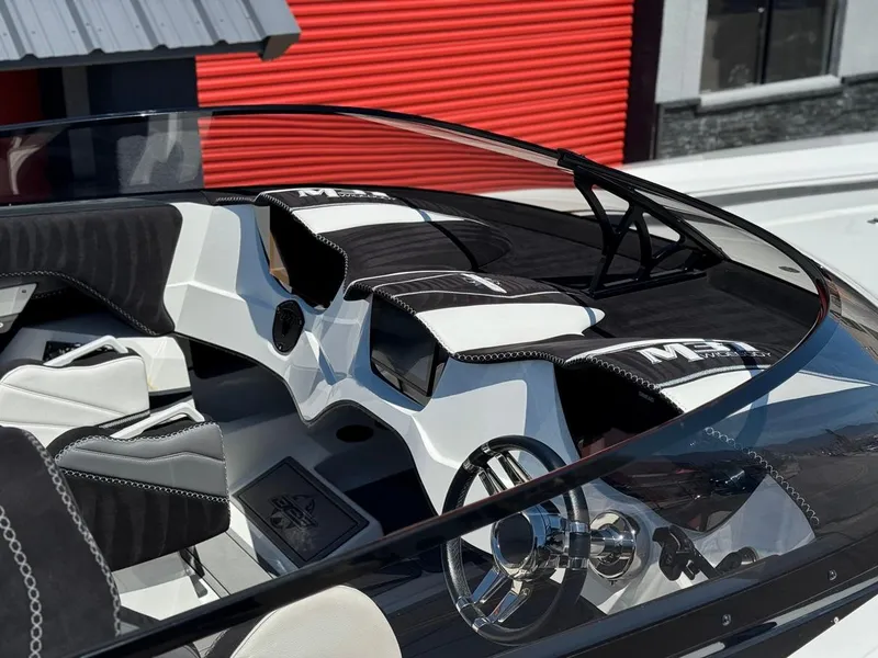 Slide: The Image of 2016 Daves Custom Boats M31 interior with sleek black and white design, modern dashboard. - 8