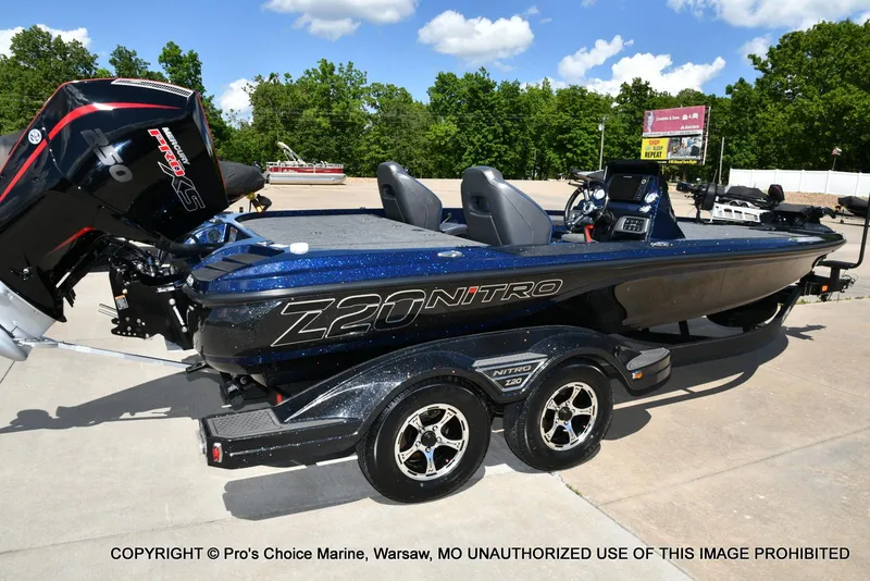 Slide: The Image of 2021 Nitro Z20 boat with Mercury engine on trailer, parked outdoors. - 17
