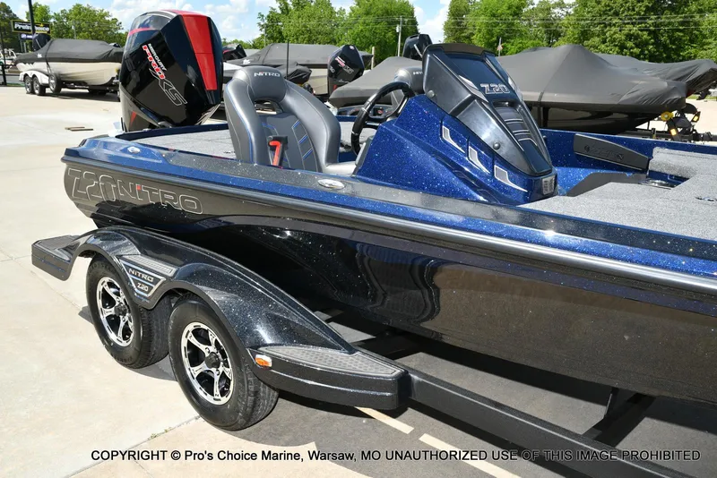 Slide: The Image of 2021 Nitro Z20 boat with sleek design and powerful engine, parked outdoors. - 2