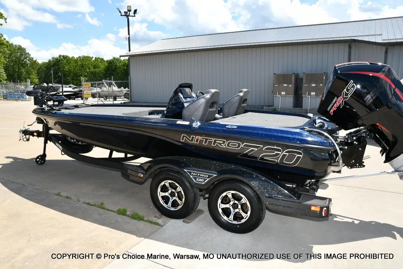 Slide: The Image of 2021 Nitro Z20 boat with trailer, parked outdoors near a building. - 26