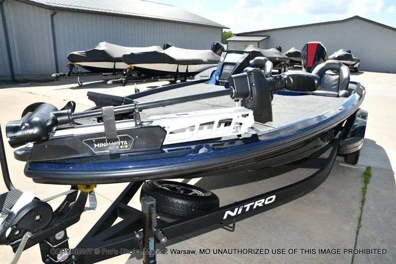 Slide: The Image of 2021 Nitro Z20 boat with Minn Kota trolling motor on trailer, parked outdoors. - 29