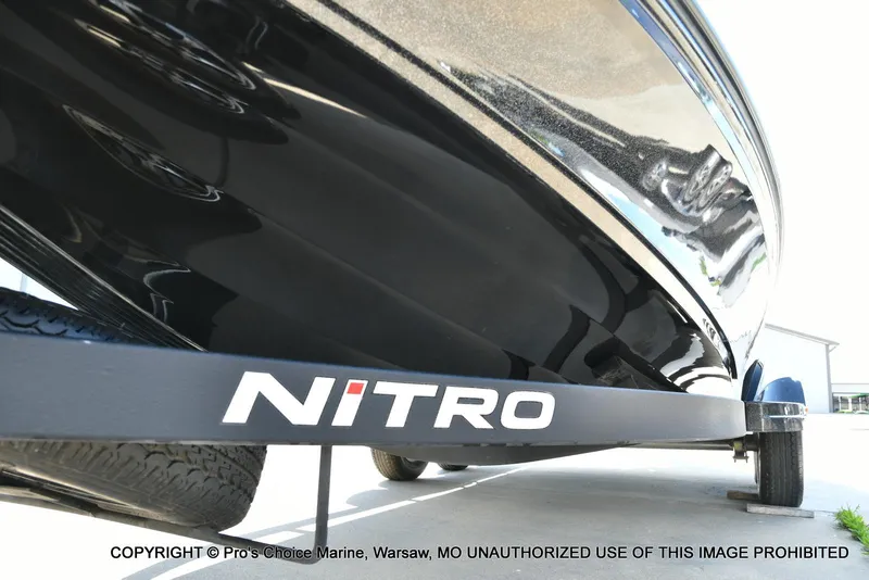 Slide: The Image of 2021 Nitro Z20 boat on trailer, close-up view of hull and logo. - 34