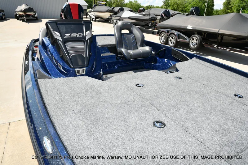 Slide: The Image of 2021 Nitro Z20 boat with spacious deck and sleek design in a marina setting. - 36