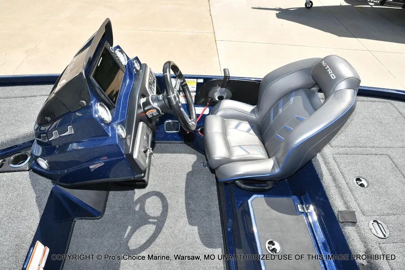 Slide: The Image of Nitro Z20 2021 boat interior with steering wheel and cushioned seat. - 44