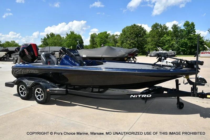 Slide: The Image of 2021 Nitro Z20 boat on trailer in sunny outdoor setting. - 79