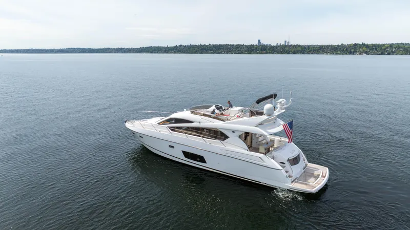 The Image of 2012 Sunseeker Manhattan 63 yacht cruising on a calm lake. - 0