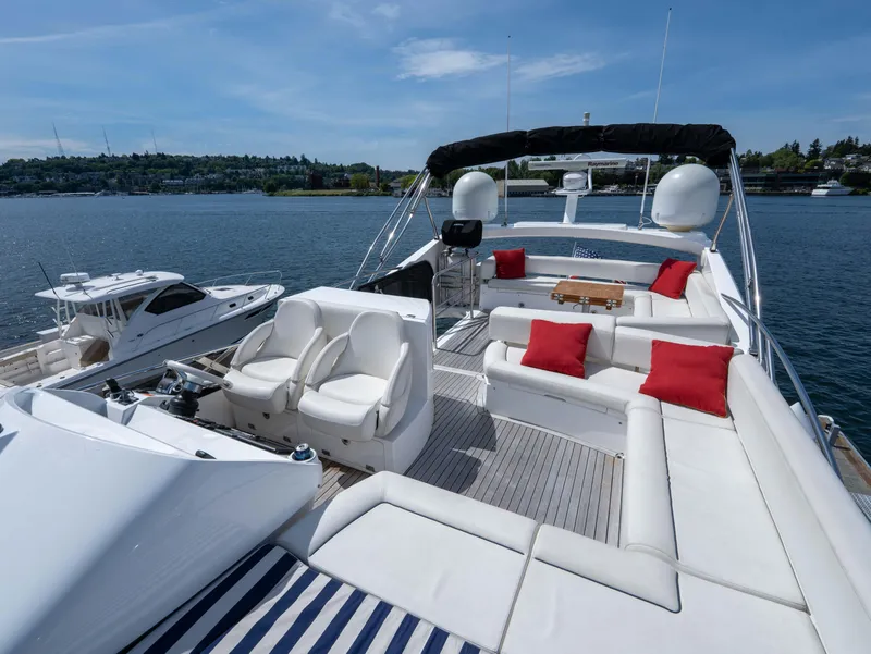 Slide: The Image of Luxurious 2012 Sunseeker Manhattan 63 yacht with spacious deck and red-accented seating. - 12