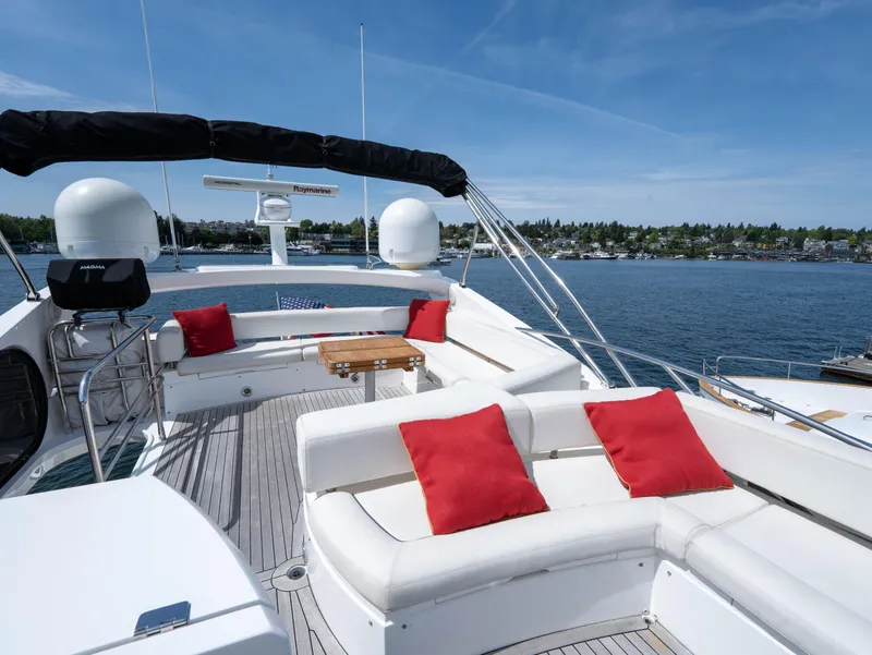 Slide: The Image of Luxurious 2012 Sunseeker Manhattan 63 yacht deck with red cushions and scenic water view. - 14