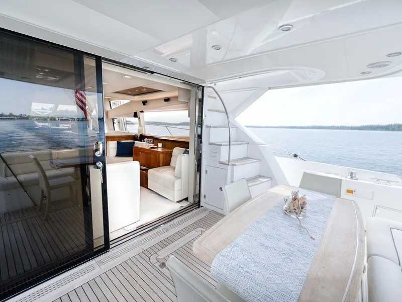 Slide: The Image of Luxurious 2012 Sunseeker Manhattan 63 yacht interior with elegant dining area and scenic ocean view. - 19