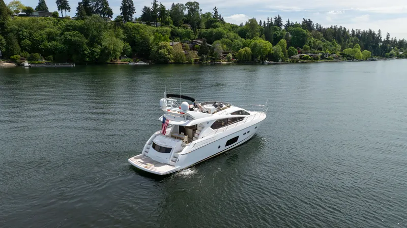 Slide: The Image of Luxurious 2012 Sunseeker Manhattan 63 yacht cruising on a serene lake. - 2
