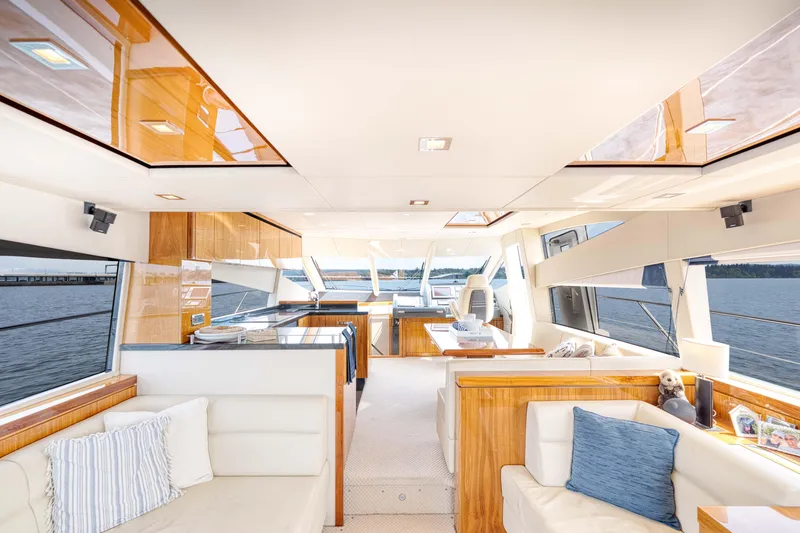 Slide: The Image of Luxurious interior of a 2012 Sunseeker Manhattan 63 yacht with elegant furnishings and panoramic windows. - 21