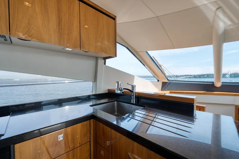 Slide: The Image of Luxurious kitchen interior of 2012 Sunseeker Manhattan 63 yacht with sleek wood cabinetry. - 33