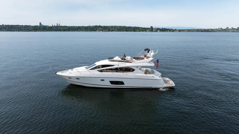 Slide: The Image of 2012 Sunseeker Manhattan 63 yacht cruising on open water. - 4
