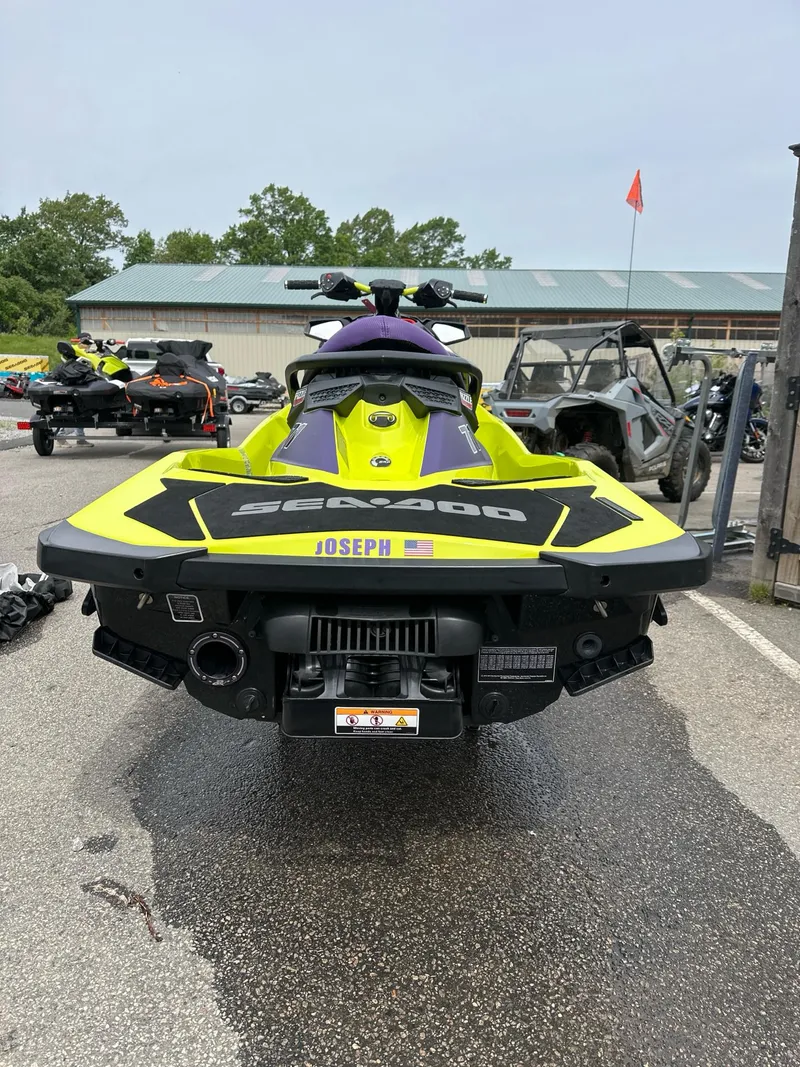 Slide: The Image of 2019 Sea-Doo RXP-X 300 iBR jet ski, vibrant yellow, parked outdoors. - 3
