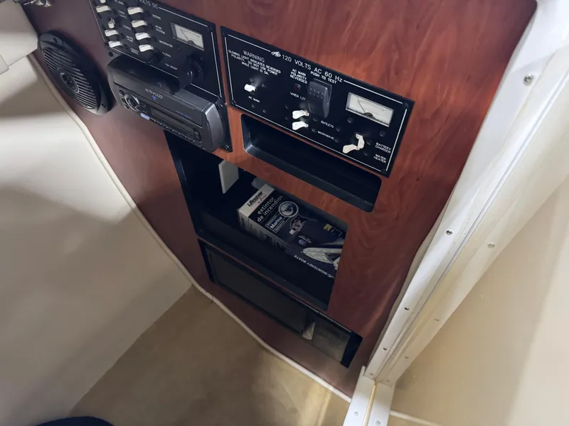 Slide: The Image of Control panel inside 2007 Monterey 298 boat, featuring switches and gauges. - 13