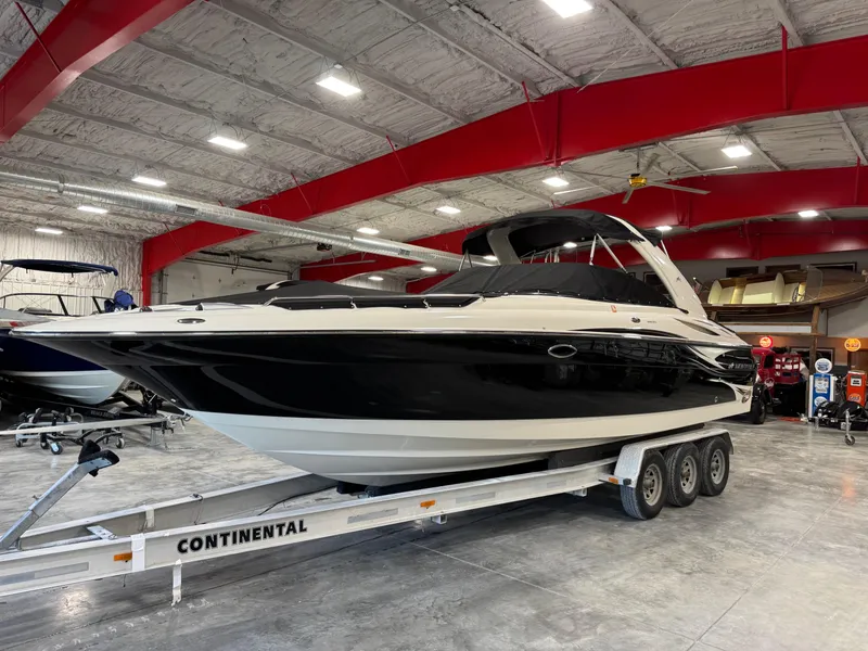 Slide: The Image of 2007 Monterey 298 boat on trailer in indoor showroom with red beams. - 16