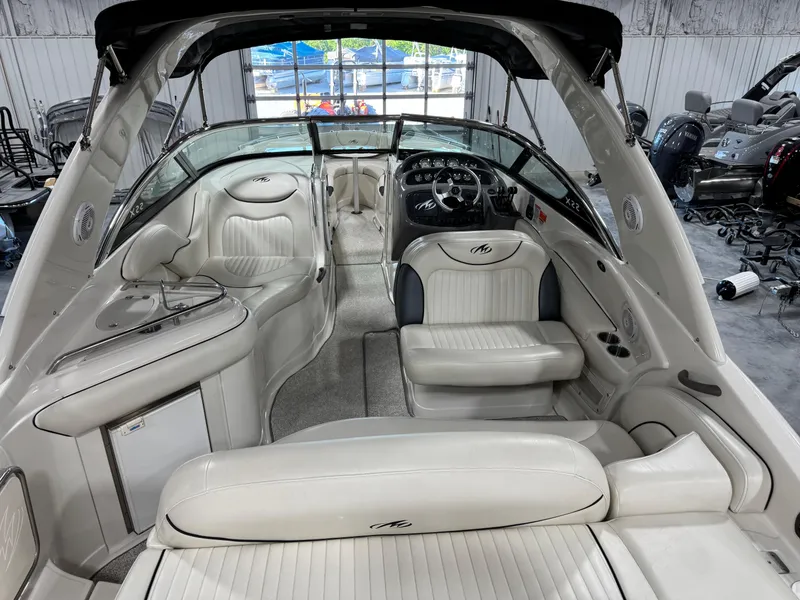 Slide: The Image of 2007 Monterey 298 boat interior with white leather seating and sleek dashboard design. - 7