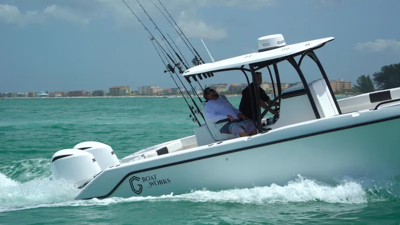 Slide: The Image of 2022 CG Boat Works 35 M-Series cruising on turquoise waters with fishing rods. - 22