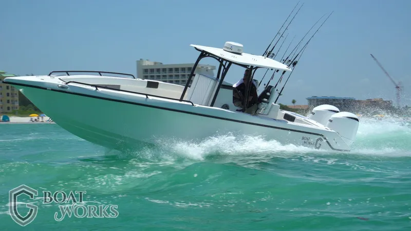 Slide: The Image of 2022 CG Boat Works 35 M-Series cruising on turquoise water, showcasing sleek design and performance. - 25