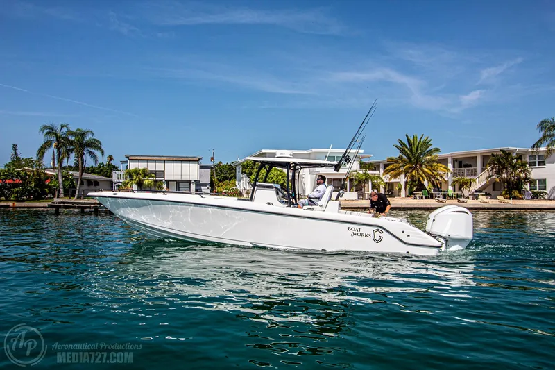 Slide: The Image of 2022 CG Boat Works 35 M-Series cruising on a sunny day near waterfront homes. - 27