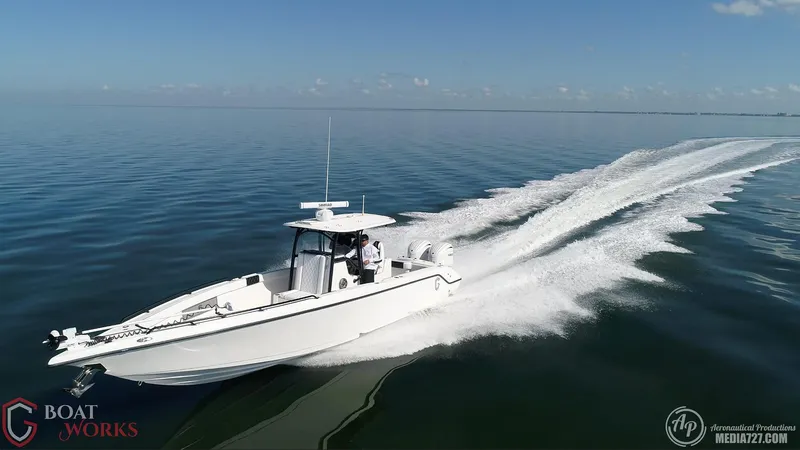 Slide: The Image of 2022 CG Boat Works 35 M-Series speeding on calm water, leaving a trail. - 3