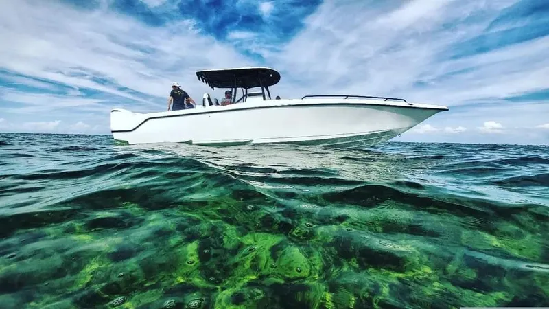 Slide: The Image of 2022 CG Boat Works 35 M-Series on clear ocean water under a vibrant sky. - 45