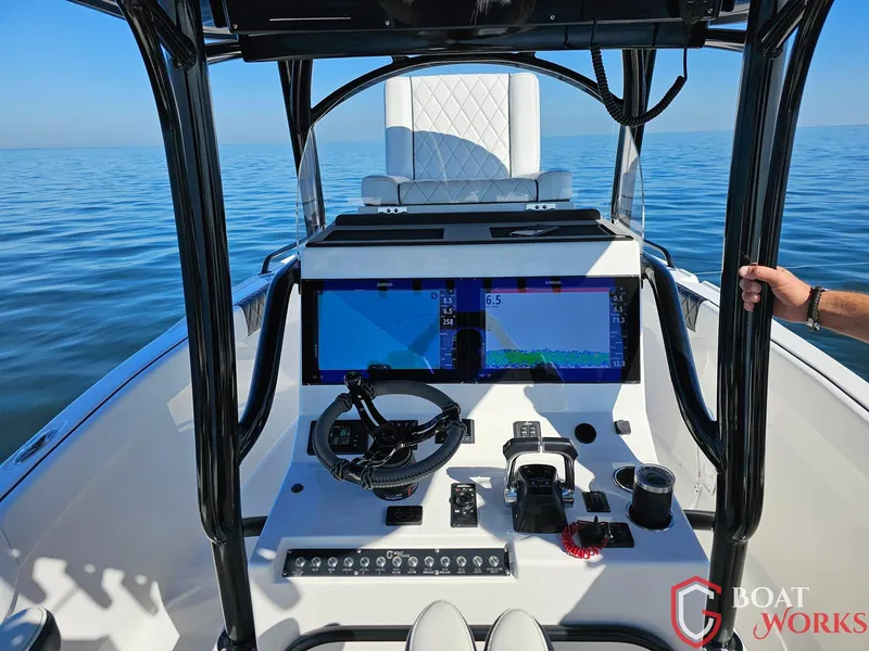 Slide: The Image of 2022 CG Boat Works 35 M-Series dashboard with dual screens on calm water. - 9