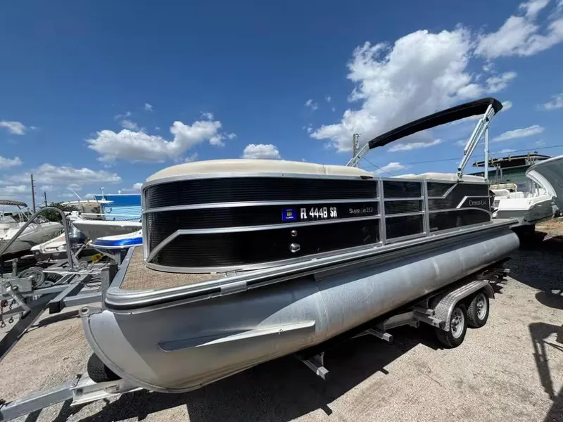Slide: The Image of 2019 Cypress Cay Sea Breeze 212 pontoon boat on trailer under blue sky. - 2