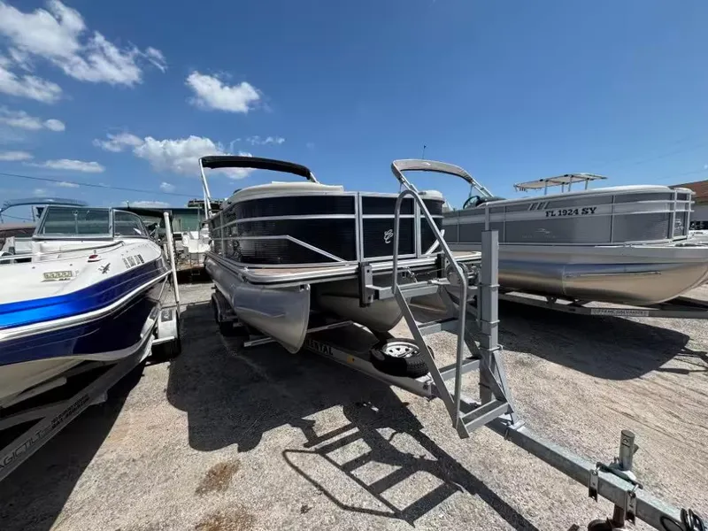 Slide: The Image of 2019 Cypress Cay Sea Breeze 212 pontoon boat on trailer under clear blue sky. - 4