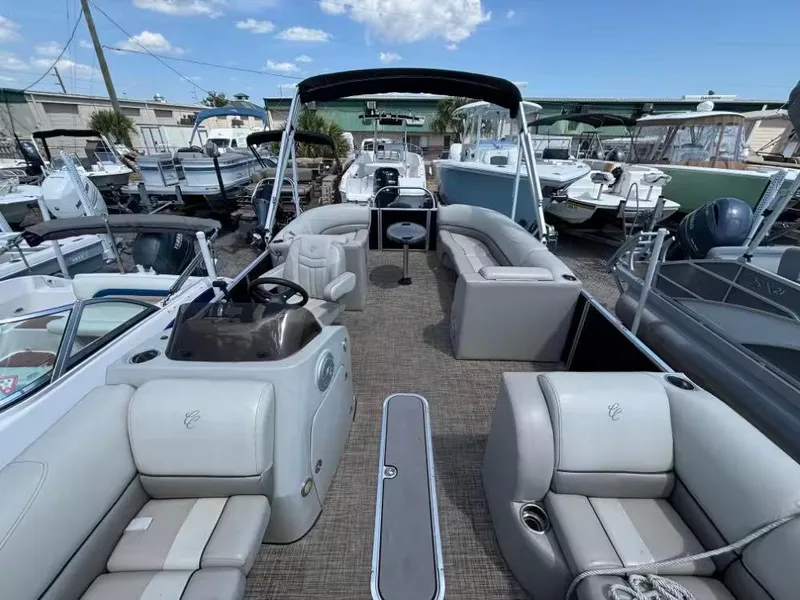 Slide: The Image of 2019 Cypress Cay Sea Breeze 212 pontoon boat with spacious seating, docked among other boats. - 8