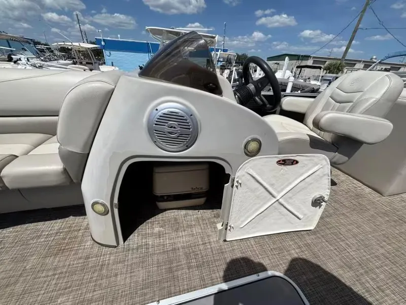 Slide: The Image of 2019 Cypress Cay Sea Breeze 212 boat interior with open storage compartment and seating. - 9