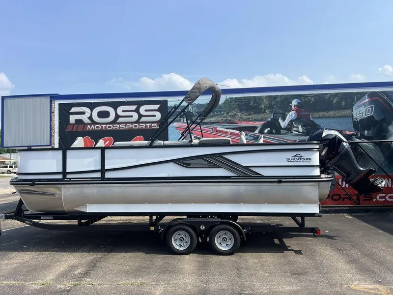 Slide: The Image of 2025 SunCatcher Fusion 322 FC pontoon boat on trailer at Ross Motorsports dealership. - 1
