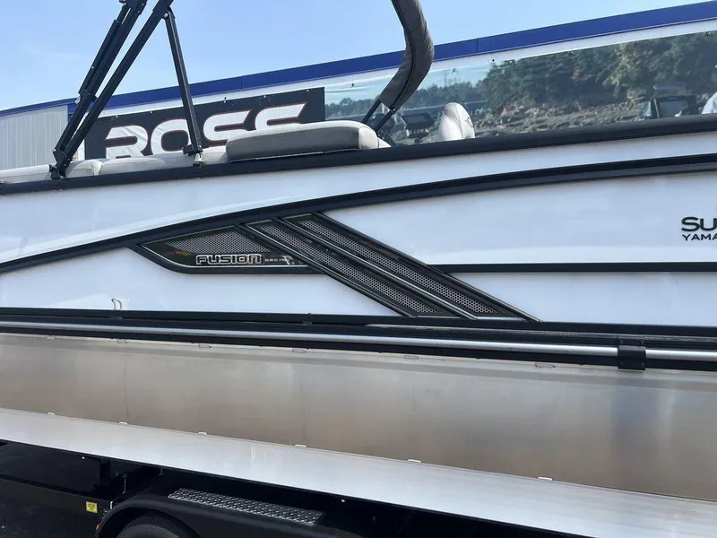 Slide: The Image of 2025 SunCatcher Fusion 322 FC boat side view with sleek design and branding. - 11