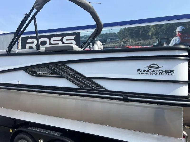 Slide: The Image of 2025 SunCatcher Fusion 322 FC boat by Yamaha, displayed on a trailer. - 12