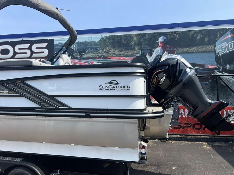 Slide: The Image of 2025 SunCatcher Fusion 322 FC boat with Yamaha engine displayed outdoors. - 13