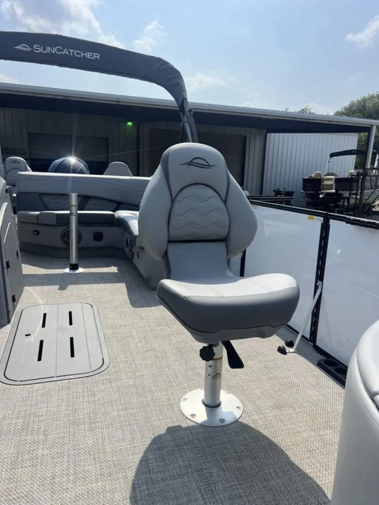 Slide: The Image of 2025 SunCatcher Fusion 322 FC boat interior with gray seating and canopy. - 15