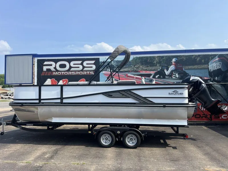 Slide: The Image of 2025 SunCatcher Fusion 322 FC pontoon boat on trailer at Ross Motorsports dealership. - 2