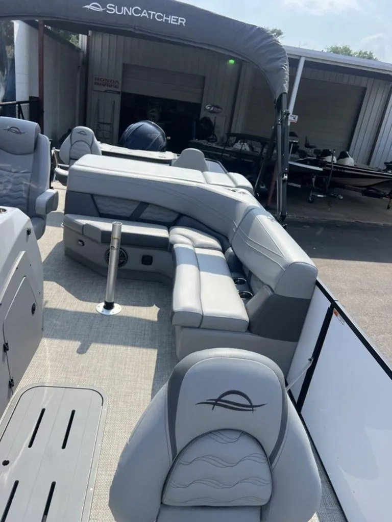 Slide: The Image of 2025 SunCatcher Fusion 322 FC pontoon boat with gray seating and canopy. - 20