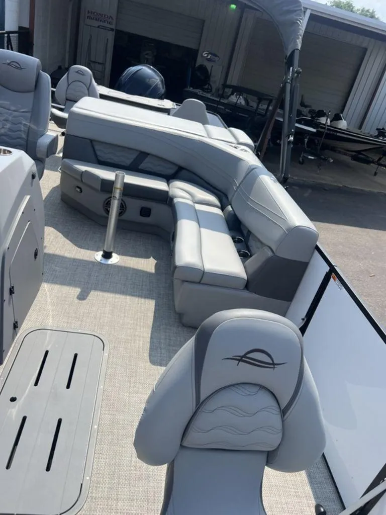 Slide: The Image of 2025 SunCatcher Fusion 322 FC boat interior with gray seating and modern design. - 23