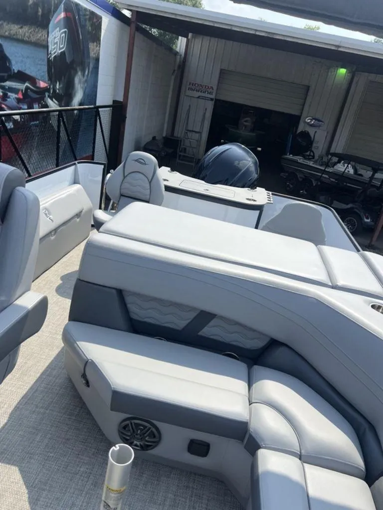 Slide: The Image of 2025 SunCatcher Fusion 322 FC boat interior with gray seating and modern design. - 25