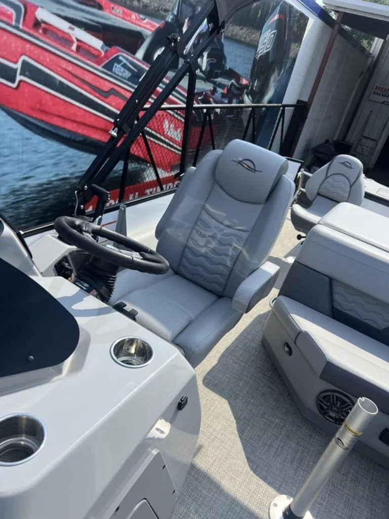 Slide: The Image of 2025 SunCatcher Fusion 322 FC boat interior with modern seating and steering wheel. - 26