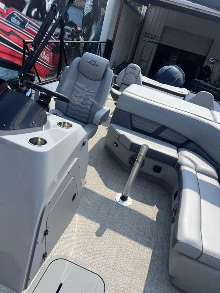 Slide: The Image of 2025 SunCatcher Fusion 322 FC boat interior with modern seating and steering console. - 28