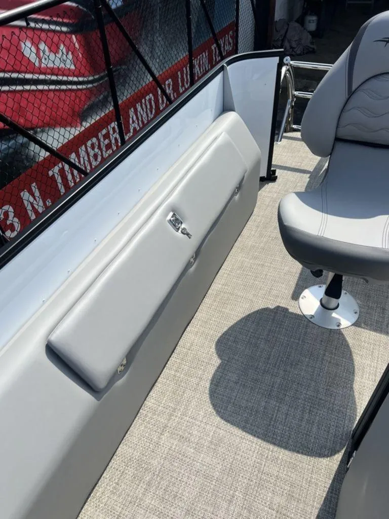 Slide: The Image of 2025 SunCatcher Fusion 322 FC boat interior with gray seating and carpeted flooring. - 30