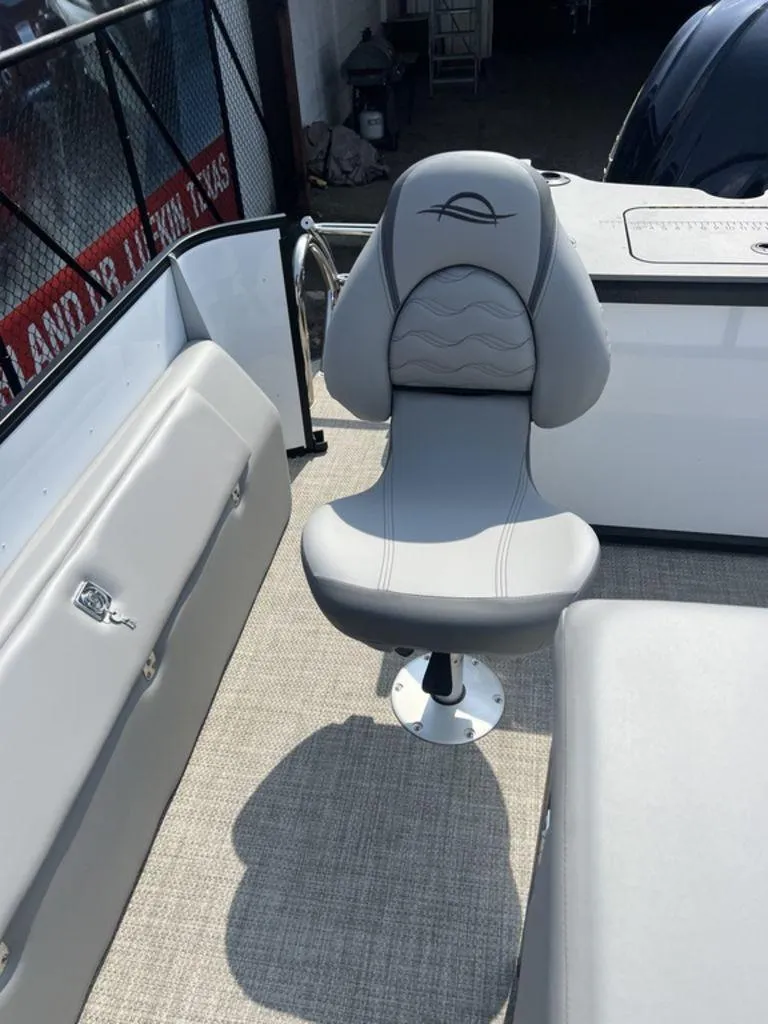 Slide: The Image of 2025 SunCatcher Fusion 322 FC boat interior with a stylish gray captain's chair. - 31