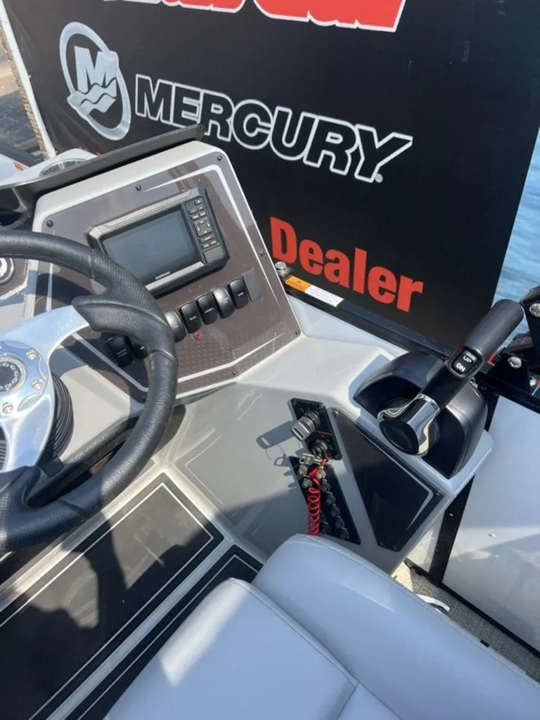 Slide: The Image of Control panel of 2025 SunCatcher Fusion 322 FC boat with Mercury branding. - 37
